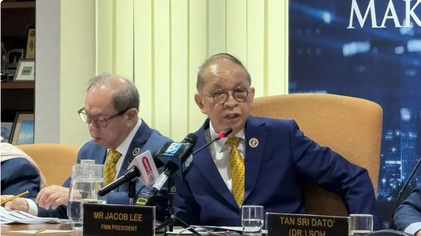 FMM president Jacob Lee Chor Kok speaking at a press conference beside his nameplate