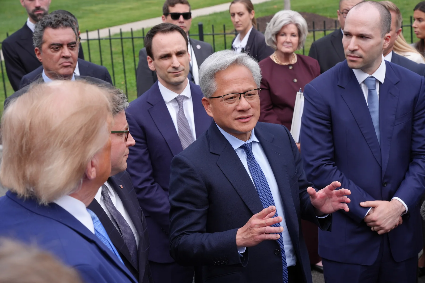 Nvidia chief executive Jensen Huang speaks to reporters outside the White House while President Trump, House Speaker Mike Johnson and OpenAI president Greg Brockman listen
