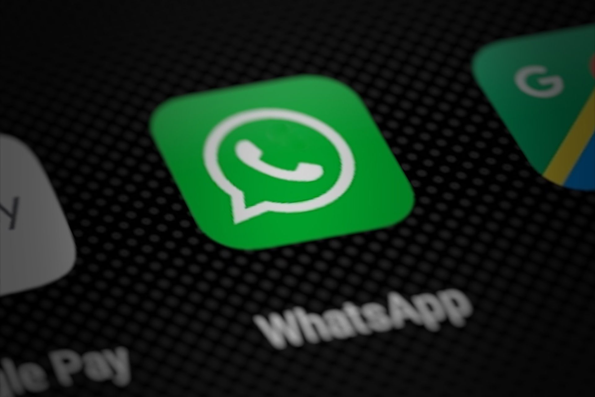A smartphone screen showing the WhatsApp app icon, the channel used in the Kuching company payment scam